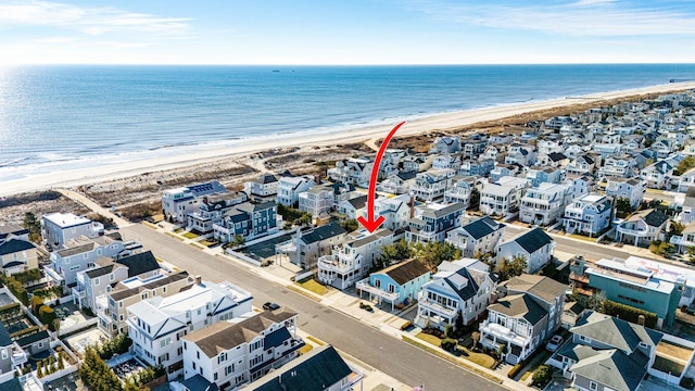 bird's eye view featuring a view of the beach and a water view