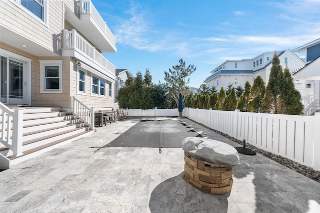 view of patio with a residential view and a fenced backyard