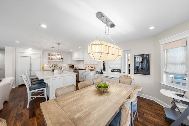 dining room with dark wood-type flooring, recessed lighting, baseboards, and a chandelier