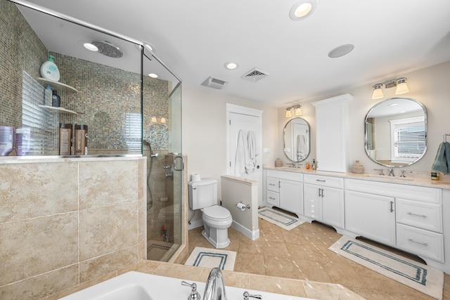 full bath featuring a garden tub, toilet, visible vents, double vanity, and a stall shower