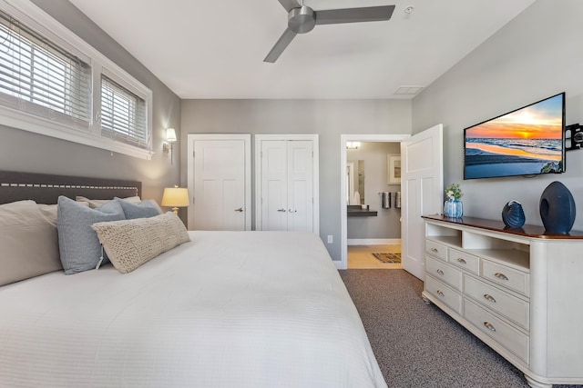 bedroom with baseboards, visible vents, connected bathroom, a ceiling fan, and carpet flooring