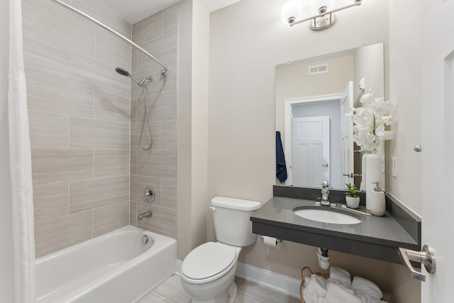 bathroom featuring bathtub / shower combination, visible vents, toilet, a sink, and baseboards