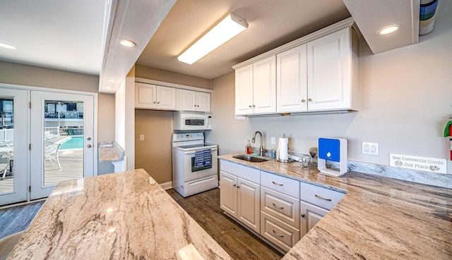 kitchen featuring light stone counters, white appliances, a sink, white cabinetry, and dark wood-style floors