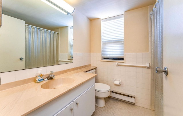 bathroom featuring a baseboard radiator, toilet, vanity, tile walls, and tile patterned floors