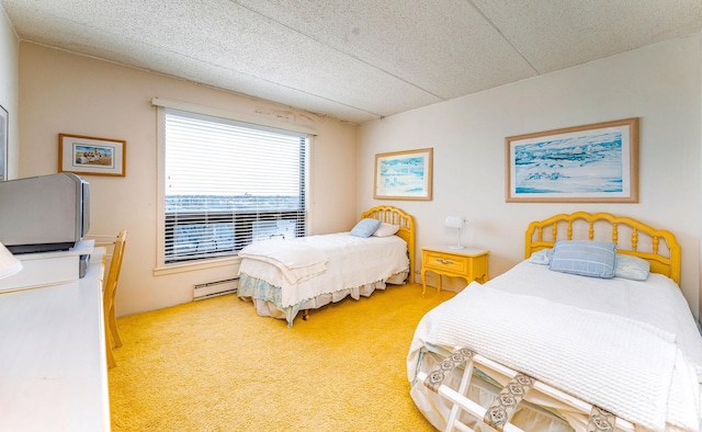 carpeted bedroom featuring a baseboard heating unit