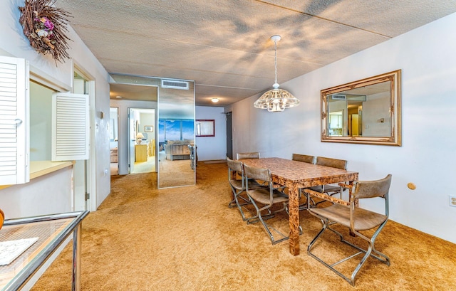 carpeted dining room with visible vents