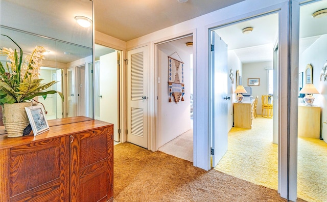 hallway featuring light colored carpet