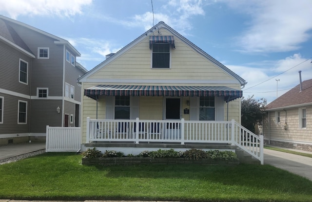 view of front of property with a front yard and a porch