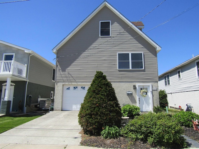 traditional home featuring an attached garage and driveway