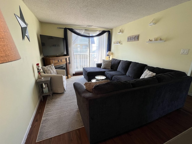 living room featuring a textured ceiling and dark hardwood / wood-style flooring