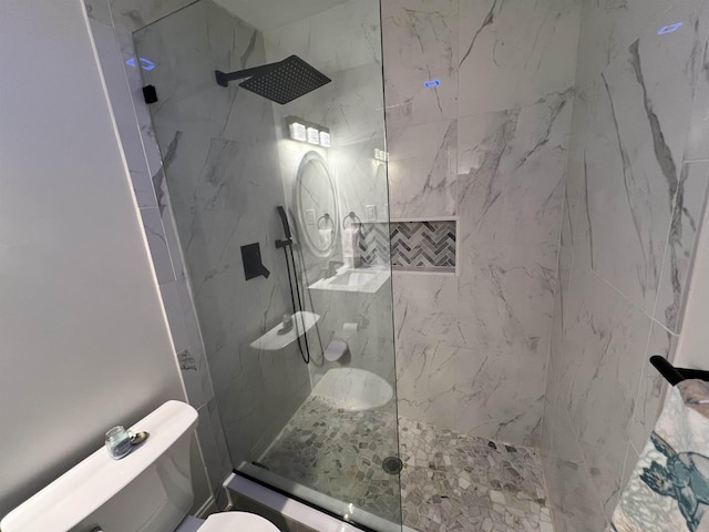 bathroom featuring toilet and tiled shower