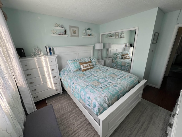 bedroom featuring a textured ceiling and a closet