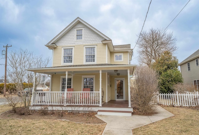 victorian home with covered porch and fence