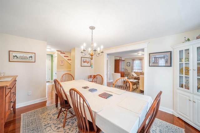 dining area with dark wood-style floors, stairway, and baseboards