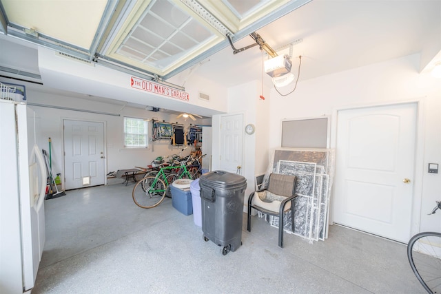 garage with white fridge with ice dispenser and a garage door opener