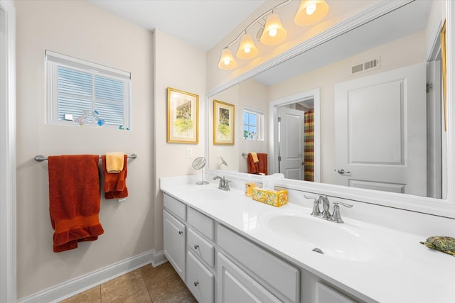 bathroom featuring tile patterned flooring and vanity