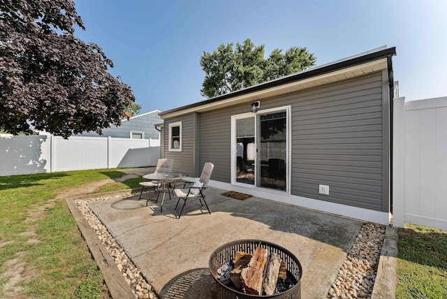 back of property featuring a lawn, a fenced backyard, outdoor dining area, and a patio area