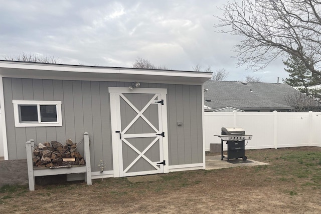 view of shed featuring fence