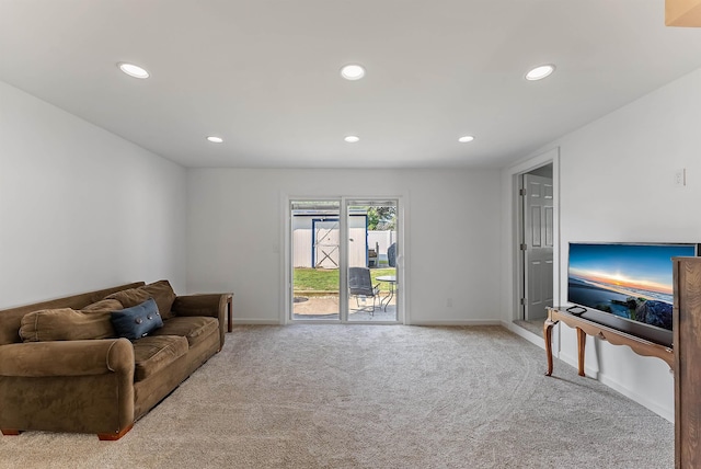 living area with baseboards, recessed lighting, and carpet