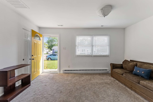 carpeted living area with visible vents and a baseboard heating unit