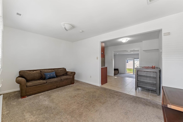 sitting room with baseboards, tile patterned floors, and carpet floors