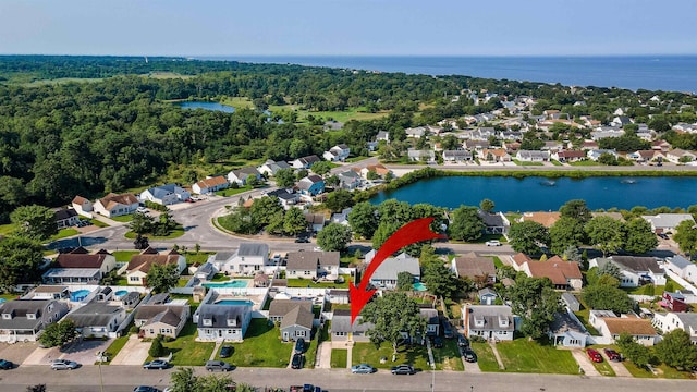 bird's eye view with a residential view and a water view