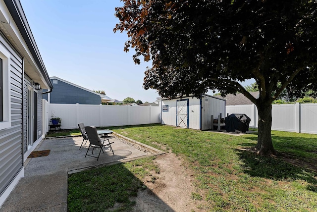 view of yard featuring an outdoor structure, a storage unit, a fenced backyard, and a patio area