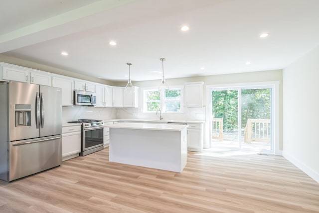80 W Rising Sun Dr, Ocean View, NJ 08230 - kitchen featuring appliances with stainless steel finishes, white cabinetry, backsplash, light countertops, and light wood-type flooring