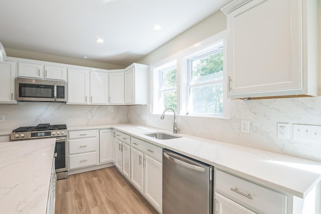 80 W Rising Sun Dr, Ocean View, NJ 08230 - kitchen with appliances with stainless steel finishes, white cabinetry, decorative backsplash, light stone counters, and recessed lighting
