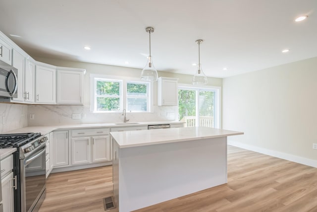 80 W Rising Sun Dr, Ocean View, NJ 08230 - kitchen featuring stainless steel appliances, backsplash, white cabinets, light wood-style floors, and recessed lighting