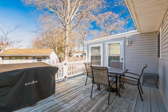 wooden terrace featuring outdoor dining area and area for grilling