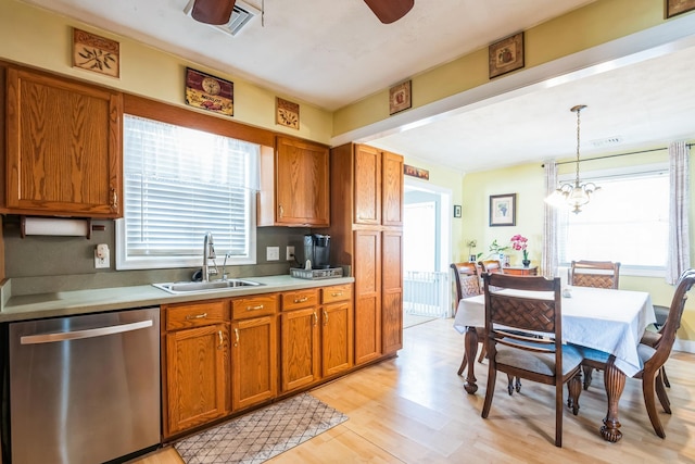 kitchen featuring pendant lighting, brown cabinets, stainless steel dishwasher, light wood-style floors, and a sink