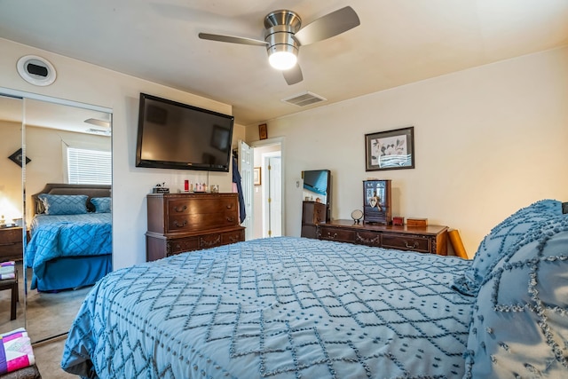 carpeted bedroom featuring a ceiling fan and visible vents