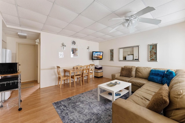 living room featuring a paneled ceiling, ceiling fan, and hardwood / wood-style floors