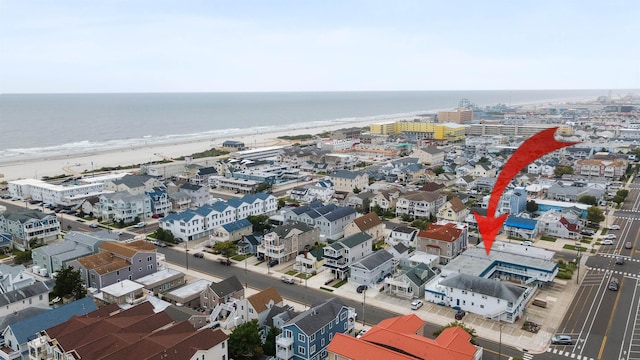 bird's eye view with a water view and a beach view