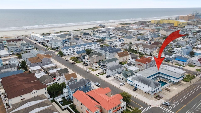 aerial view with a water view and a view of the beach