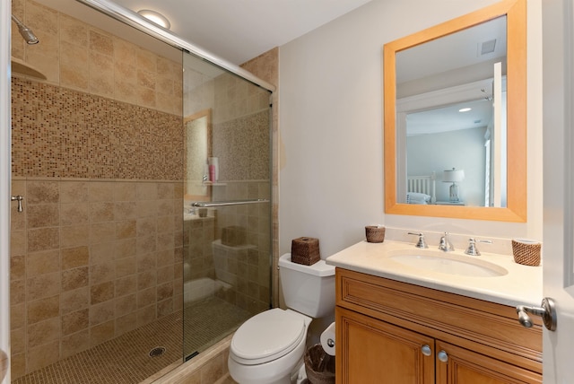 bathroom with toilet, vanity, and walk in shower