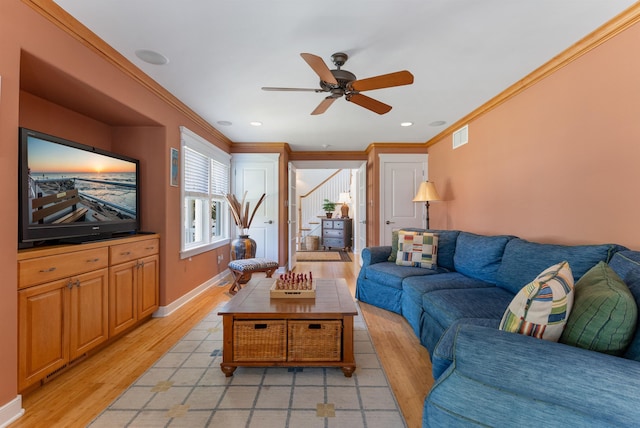 living room featuring ceiling fan, light hardwood / wood-style floors, and ornamental molding