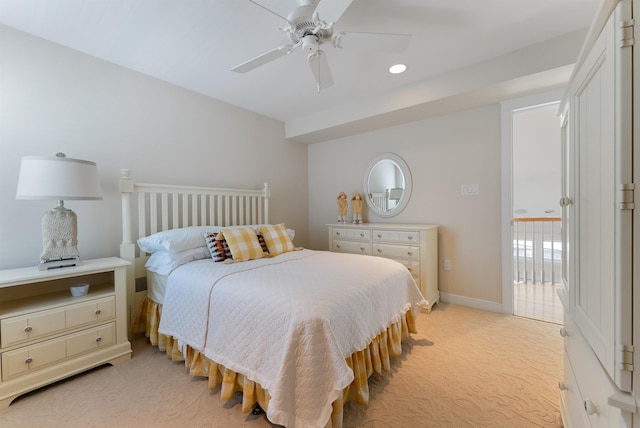 bedroom with ceiling fan and light carpet