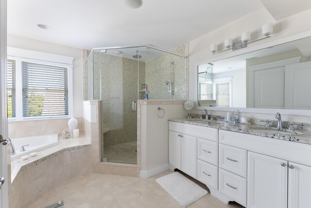 bathroom featuring tile patterned floors, vanity, and shower with separate bathtub