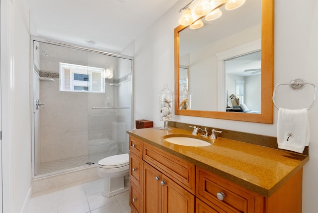 bathroom featuring tile patterned flooring, vanity, toilet, and a shower with shower door