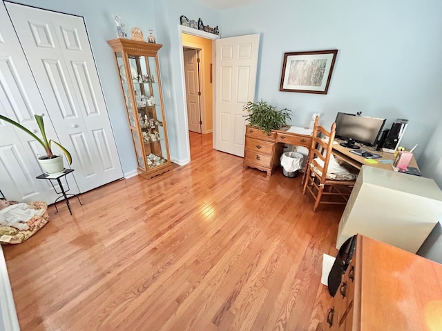 home office with light wood finished floors and baseboards