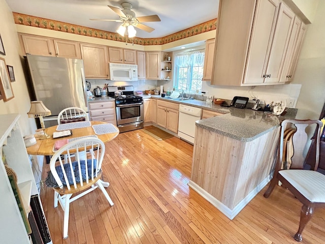 kitchen featuring light brown cabinets, appliances with stainless steel finishes, light wood-style floors, a ceiling fan, and open shelves