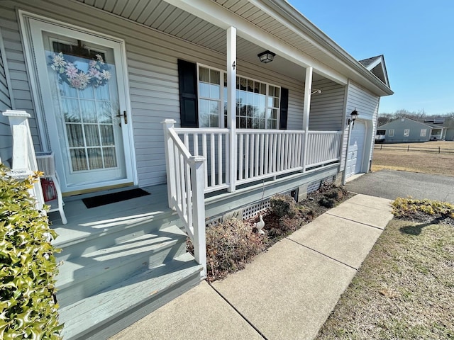 property entrance with a porch and an attached garage