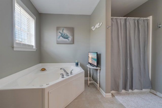 full bath with a garden tub, tile patterned flooring, baseboards, and curtained shower