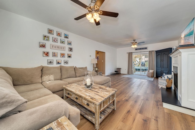 living area with ceiling fan and wood finished floors