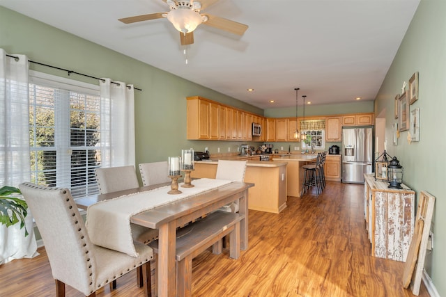 dining room with light wood-style floors, a ceiling fan, and recessed lighting