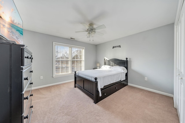 bedroom featuring light carpet, ceiling fan, visible vents, and baseboards