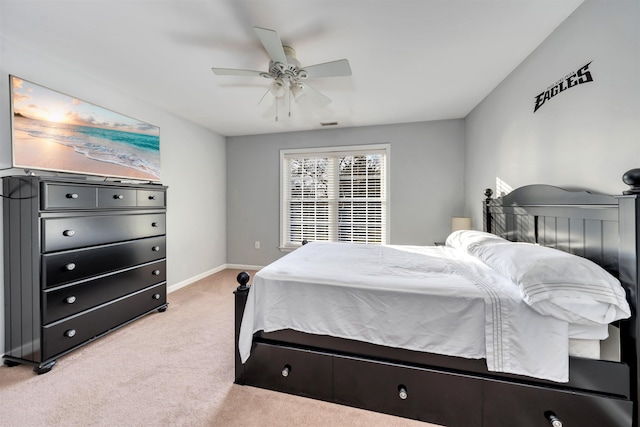 bedroom with light carpet, ceiling fan, and baseboards