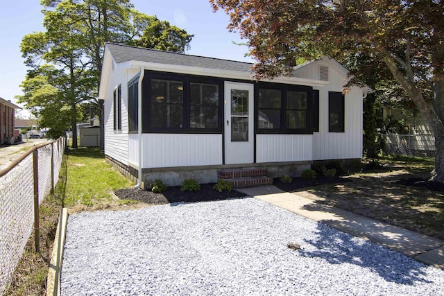 30 Pinetree Dr, Villas, NJ 08251 - view of front of home featuring a sunroom, fence, and a shingled roof